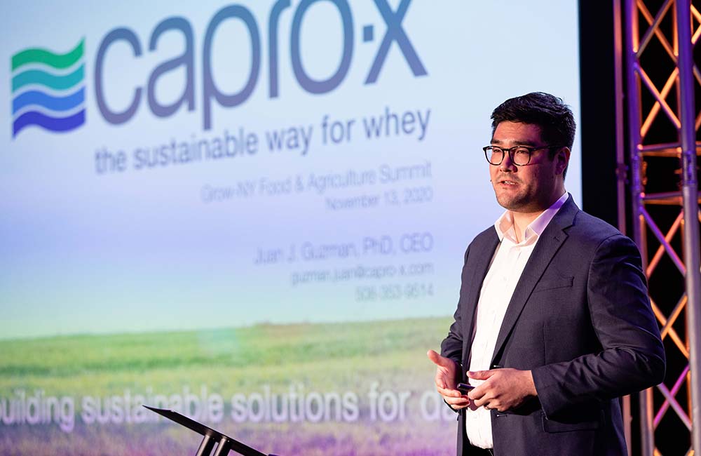Juan Guzman, founder of Capro-X, presents on stage at the Grow-NY business competition.