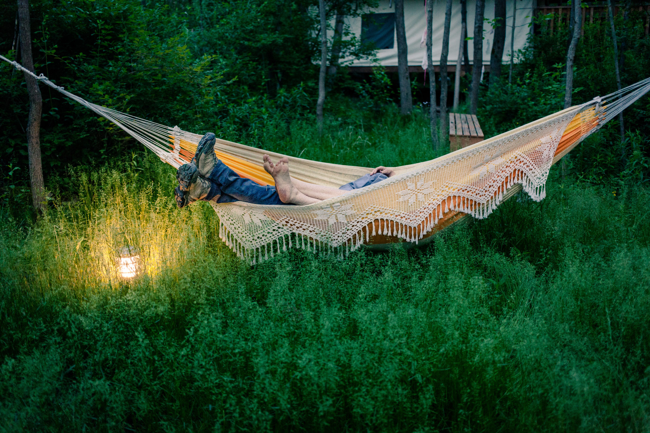 Two people swing in a hammock at Firelight Camps.