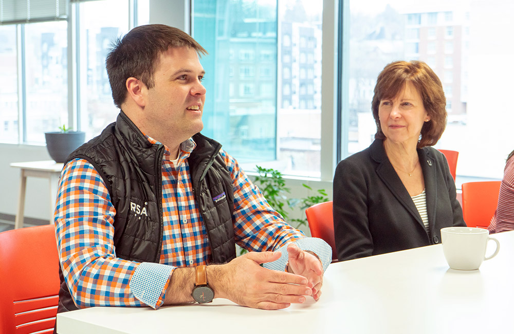 Adam Maher and Julie Baker of Ursa Space sitting at a table in Rev.