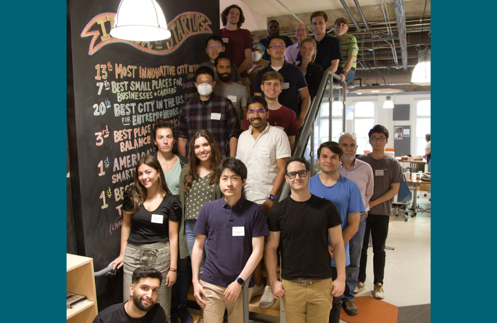 The prototyping hardware accelerator summer cohort stands on the stairs in Rev: Ithaca Startup Works