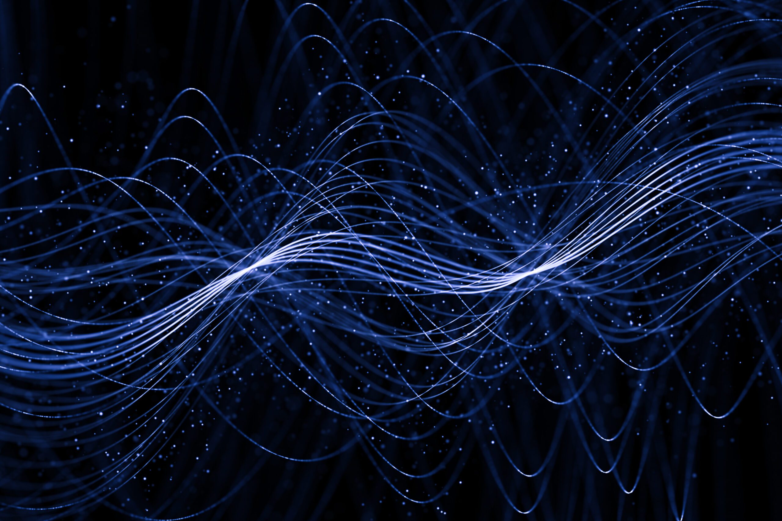 Image of a photon. Blue wavy lines on a black background.
