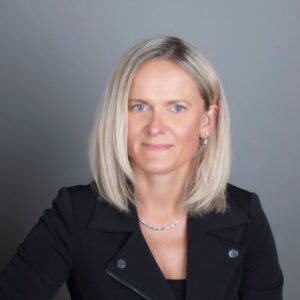 Headshot of Melanie Neumann wearing a black blazer.