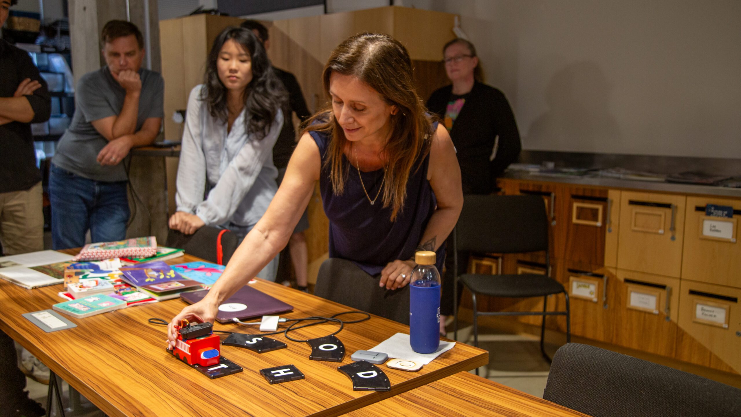 Angela Becker, Founder of Lexi-TIles, demonstrates her prototype to at the Rev Ithaca Hardware Sprint.