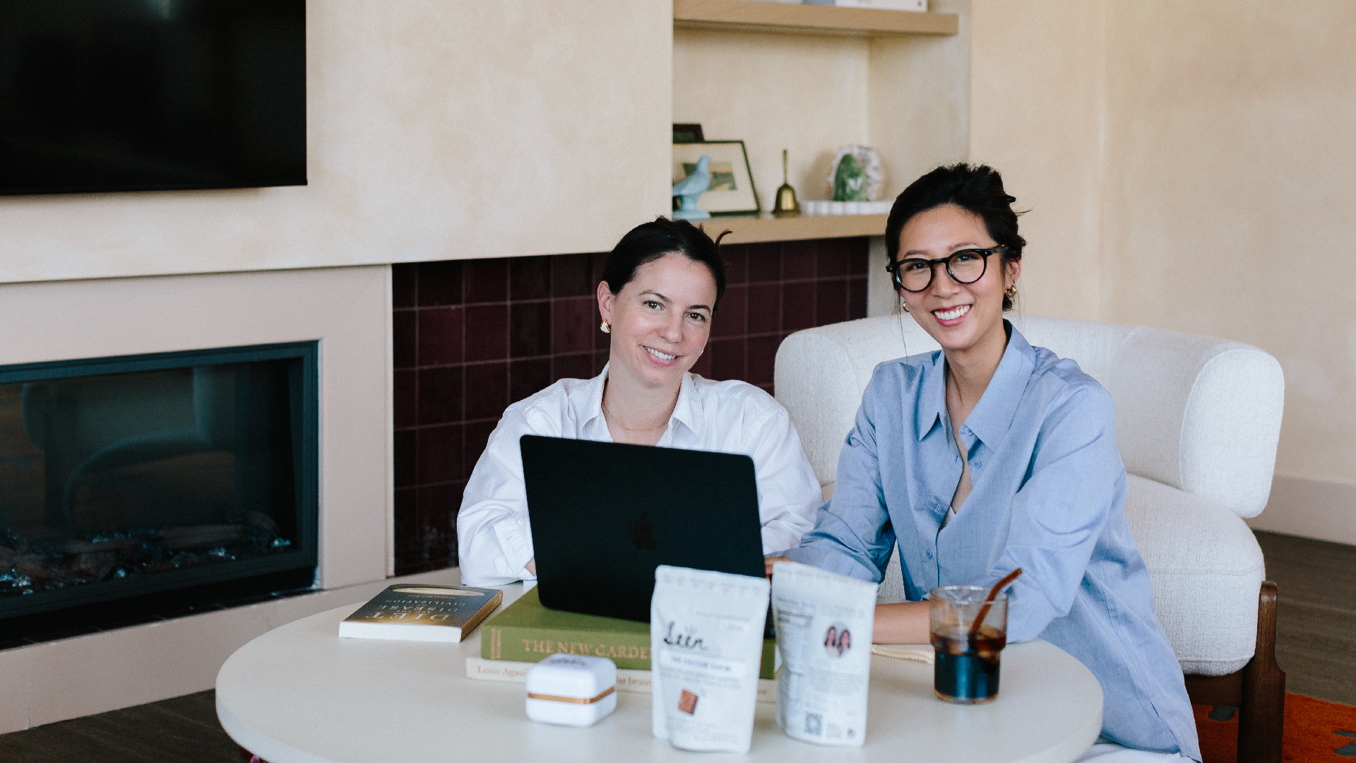 Jennifer Han and Adrienne Bitar working at a table